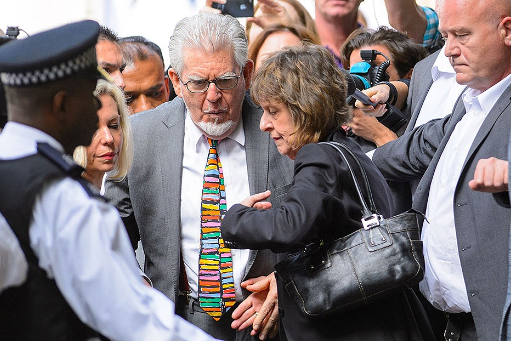 Veteran entertainer Rolf Harris arrives at Southwark Crown Court in London accompanied by his daughter Bindi, left and niece Jenny. Photo: AP