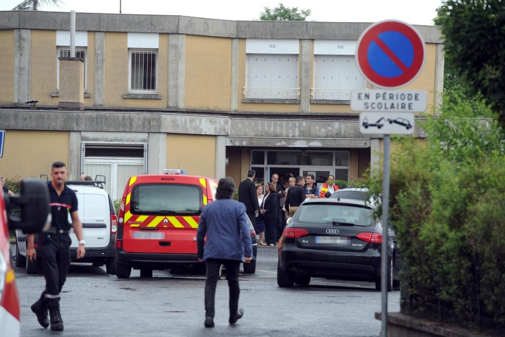 Policemen and firemen outside the school in Albi. Photo: AFP