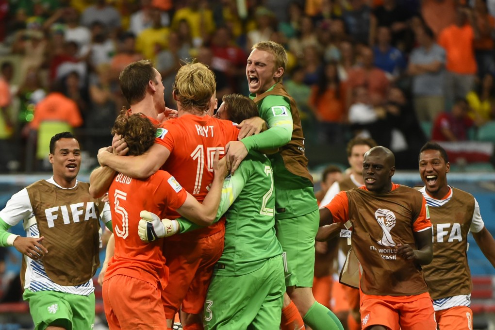 The Dutch celebrate with Tim Krul. Photo: AFP