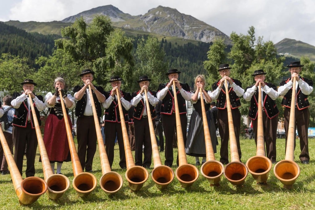 Alphorn blowers perform at the festival in Davos. Photo: EPA