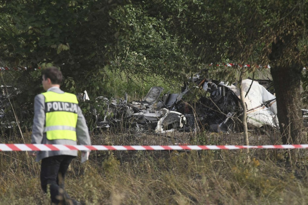 A policeman at the site of the crash in which 11 died. Photo: Reuters