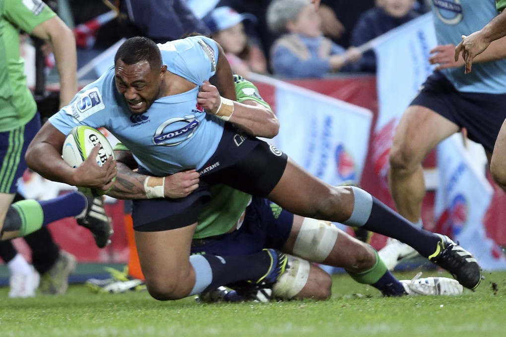 Waratahs' Wycliff Palu scores a try as he is tackled by Highlanders' Elliot Dixon during their Super 15 match in Sydney. Photo: AP