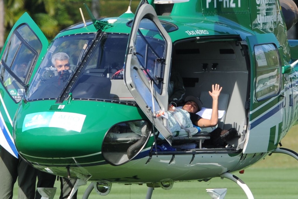 The immobilised Neymar leaves Brazil's training base by helicopter to head to his home on Saturday. Photo: AFP