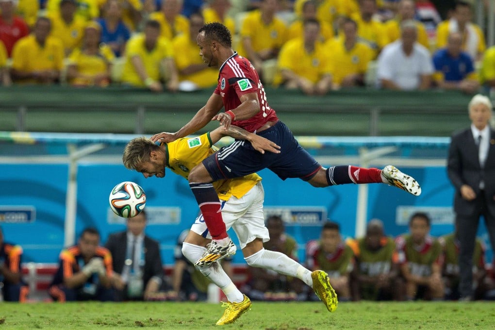 Juan Zuniga clatters into Neymar late in the game. Photo: Xinhua