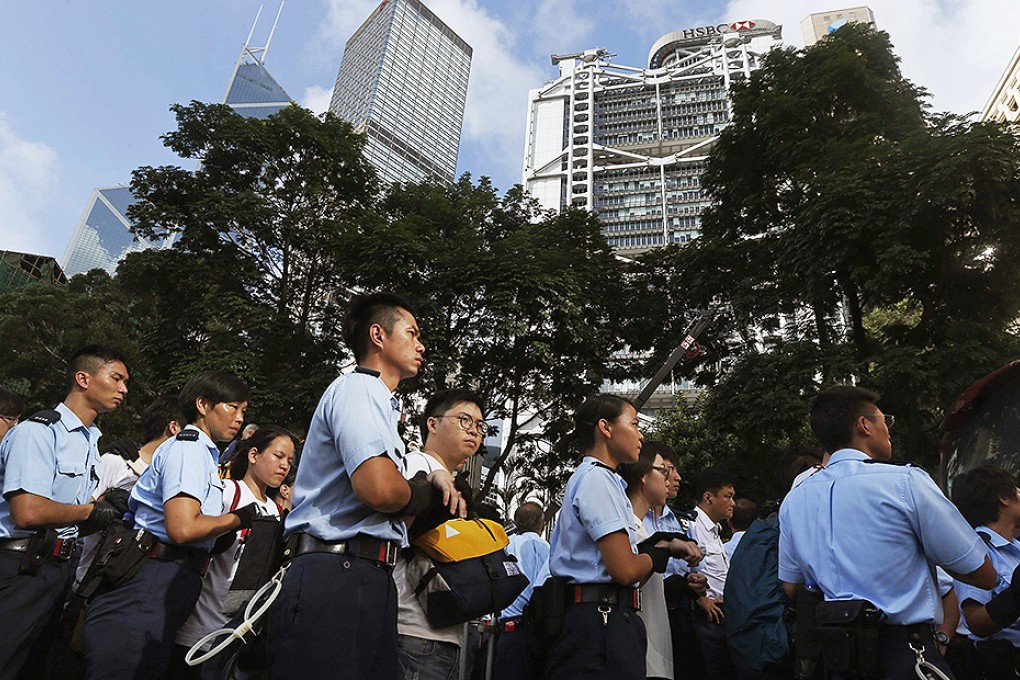 Protesters are escorted by the police on a street outside HSBC headquarters in Central district early on July 2. Photo: Reuters