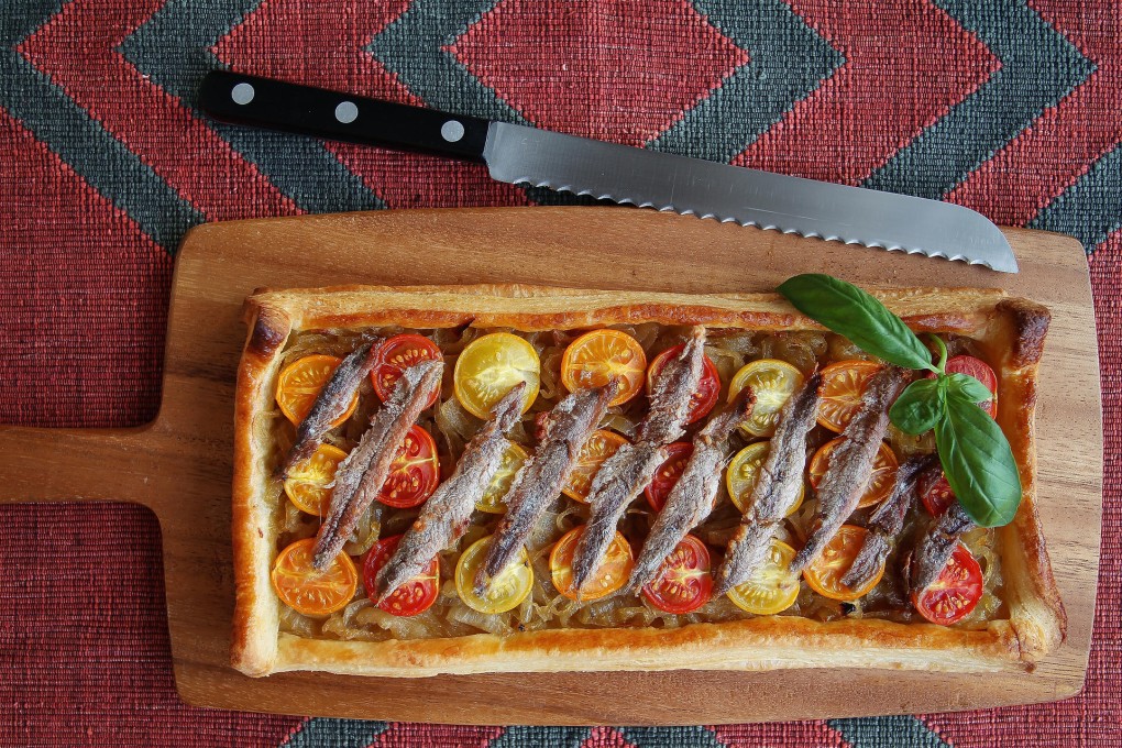Puff pastry tart with caramelised onion, cherry tomatoes and anchovies