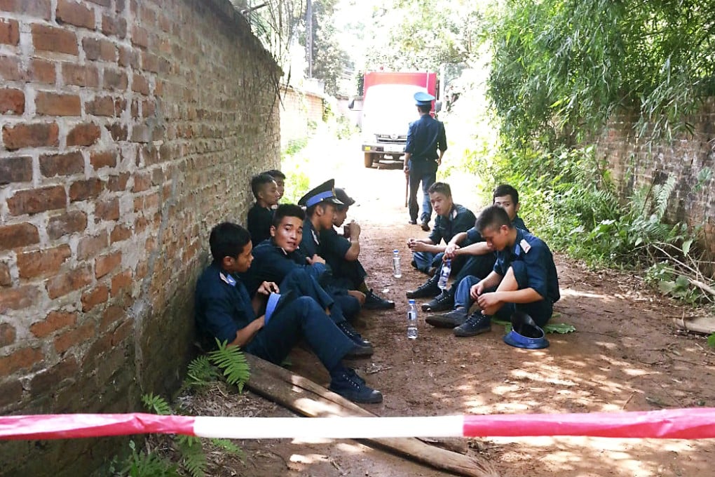 Airforce personnel guard the area outside the site of a military helicopter crash, outside Hanoi. Photo: Reuters