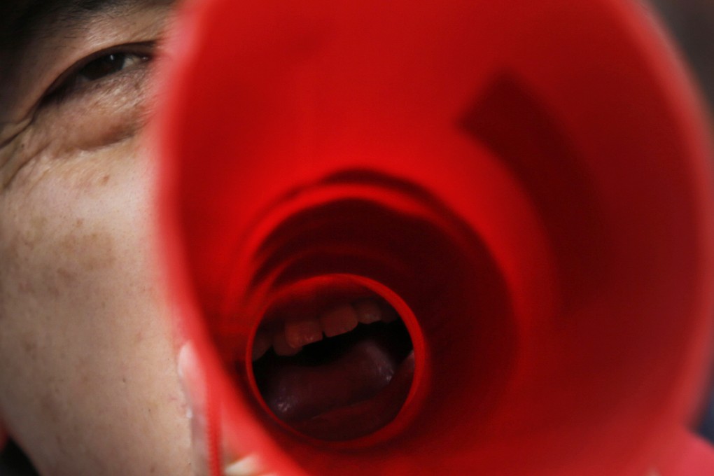 A protester against Japan's reinterpretation of Article 9 of its constitution takes a stand. Photo: AP