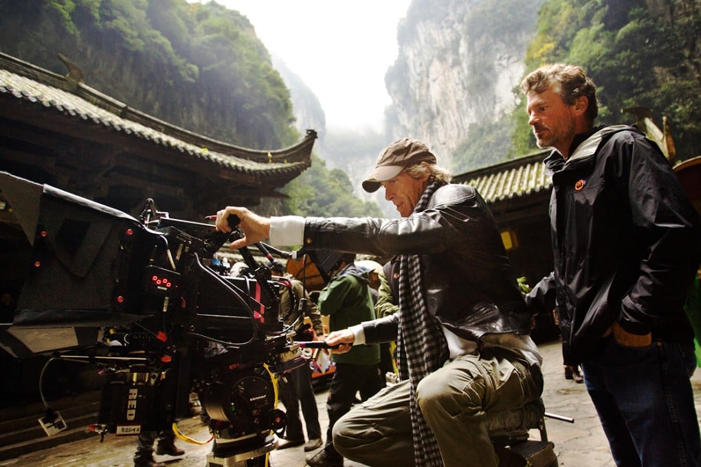 Director Michael Bay lines up a shot for camera operator John Skotchdopole in Wulong Karst National Park during a scene from Transformers: Age of Extinction. Photo: SCMP