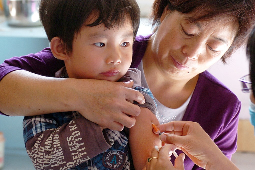 A child receives measles vaccine. Measles is making a comeback in China as millions of migrant workers miss out on vaccinations. Photo: Xinhua