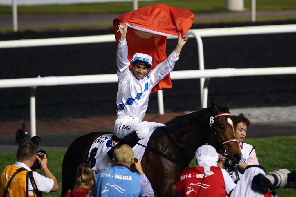 Joao Moreira flies the Hong Kong flag after winning Dubai's Al Quoz Sprint on Amber Sky. Photo: AFP
