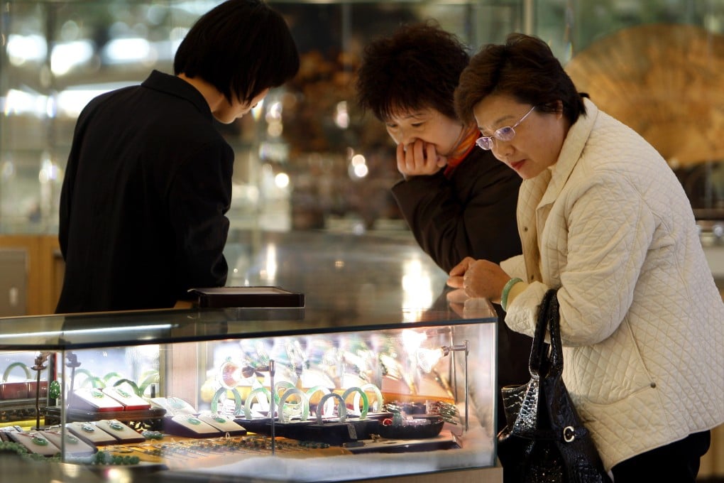 Two women look at jade at a department store in Beijing. Photo: AP