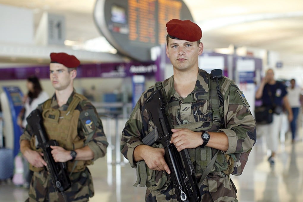 French soldiers patrol through a terminal at the Charles de Gaulle International Airport in Roissy, near Paris on Thursday. Photo: Reuters