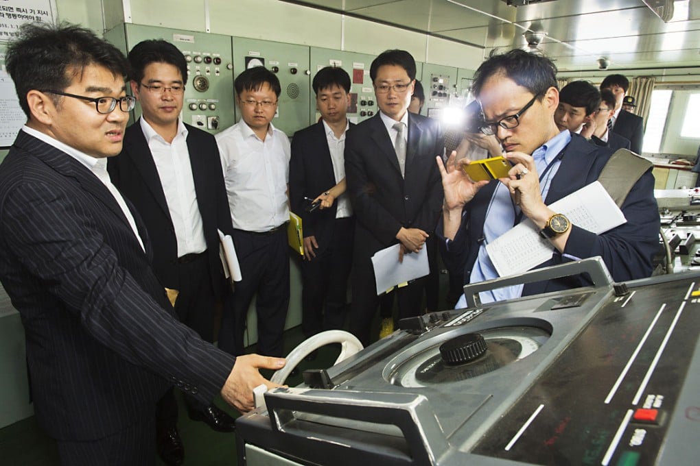 Investigators of Gwangju District Court take photos on a ferry at the port of Incheon, South Korea. An investigation was conducted on the cabin and structure of a ferry, which is of the same type with the sunken ship Sewol. Photo: Xinhua