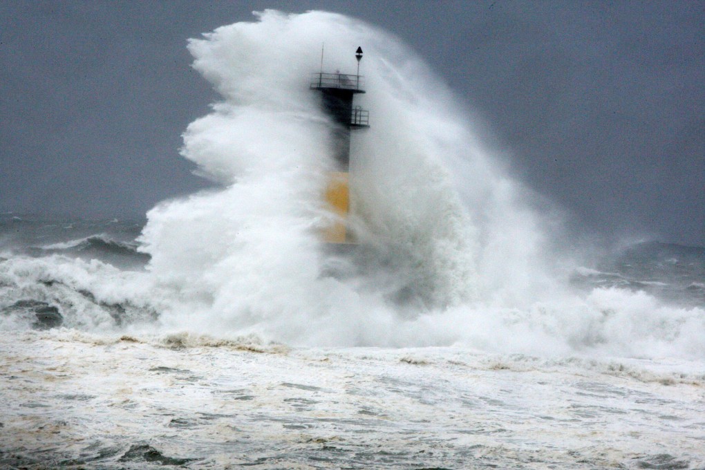 A big wave hits a lighthouse off Jeju in South Korea. Photo: AP