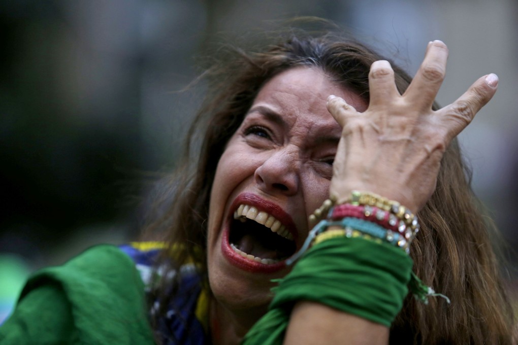 A fan cries as she watches the match in Belo Horizonte. Photo: AP