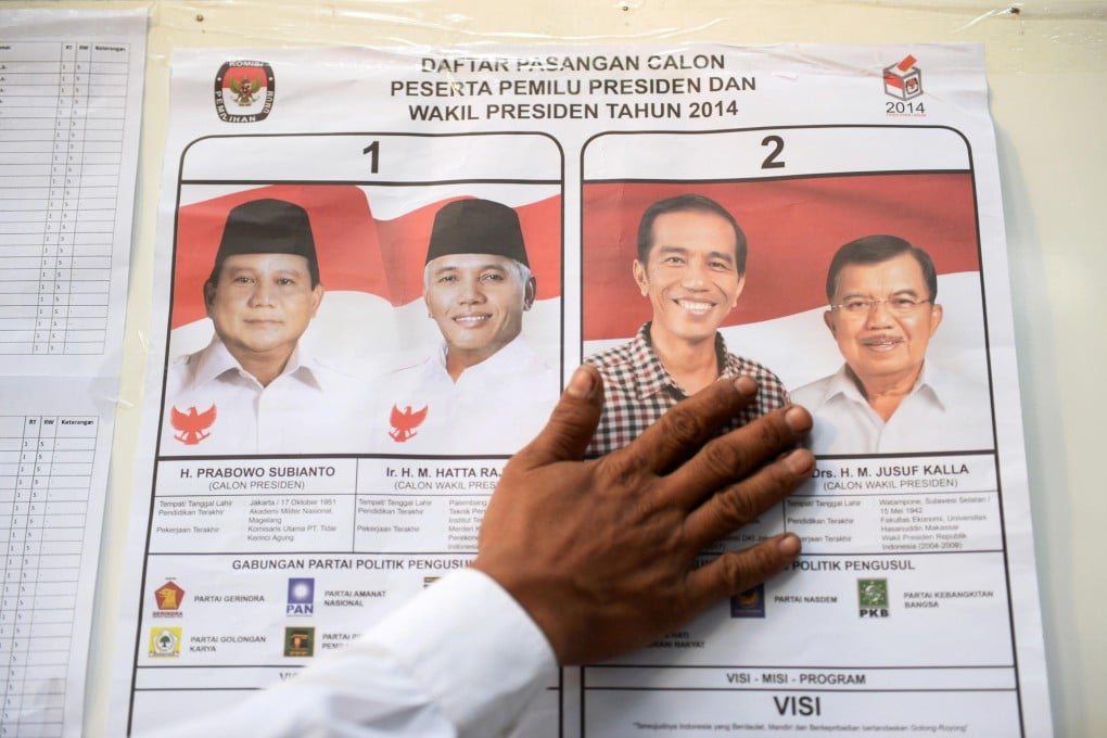 A voting guide featuring the presidential candidates Prabowo Subianto (left) and Joko Widodo (2nd right), with their respective vice presidential candidates. Photo: Bloomberg