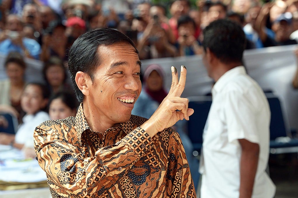 Widodo gestures after voting in Jakarta. Photo: Reuters