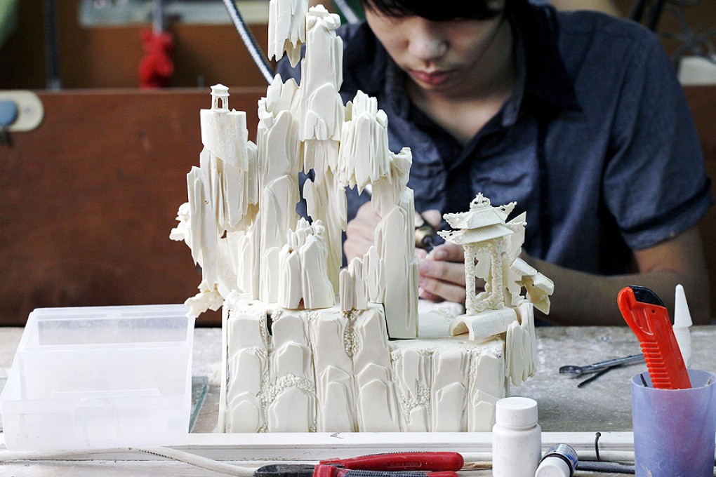 Ivory is being carved into ornate forms and figurines at a workshop in Guangzhou. Photo: Reuters