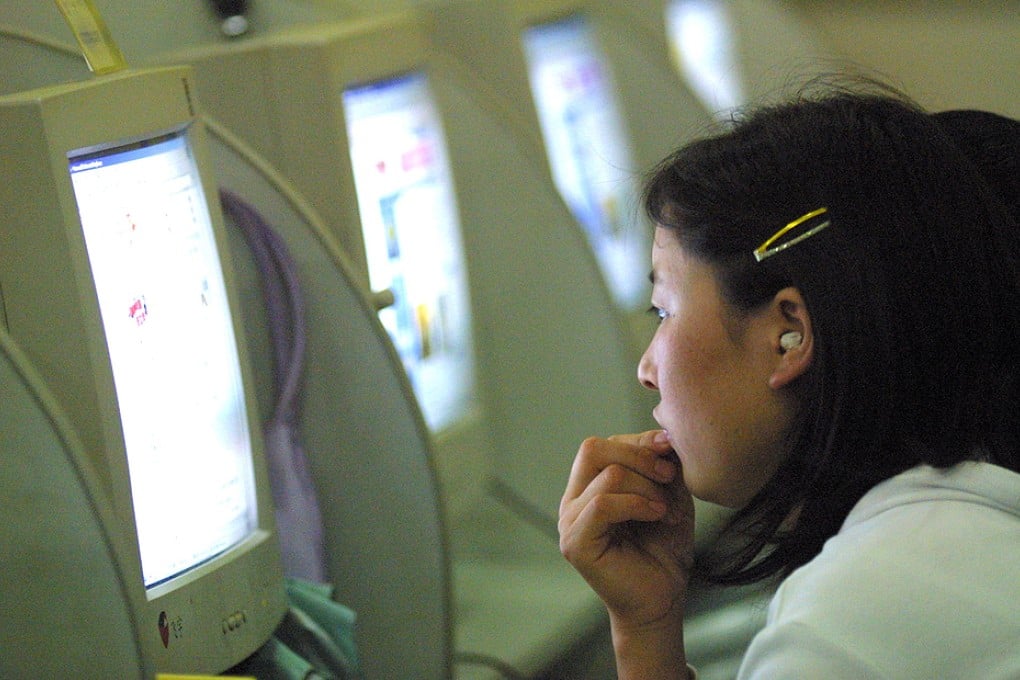 A Chinese woman uses a computer at a cyber cafe in Beijing. Photo: AP