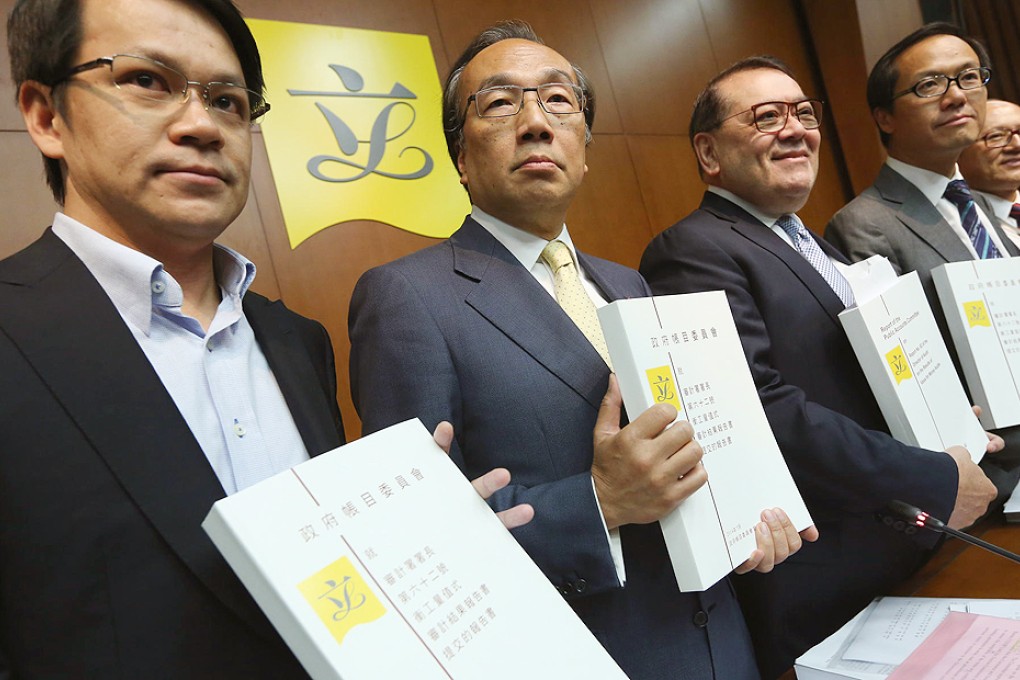 Lawmakers hold copies of the Public Accounts Committee's report into the government's handling of the Mega Events Fund. Photo: Sam Tsang