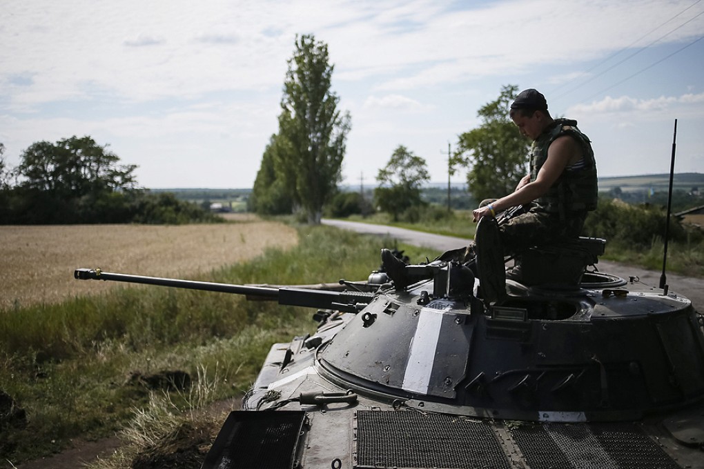 A Ukrainian soldier sits on an armoured vehicle at a position near Konstantinovka on Thursday. Photo: Reuters