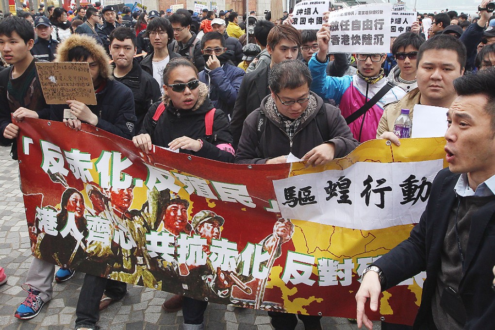 Protesters against mainland visitors march in Tsim Sha Tsui with banners containing offensive slurs. The Equal Opportunities Commission is consulting on whether or not the race discrimination law should be broadened to cover nationality. Photo: Felix Wong