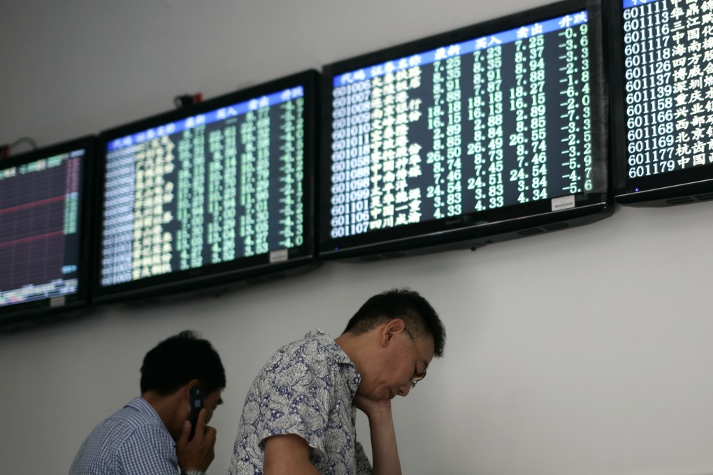 Investors trade under the stock price monitors at a private securities company in Shanghai. Photo: AP