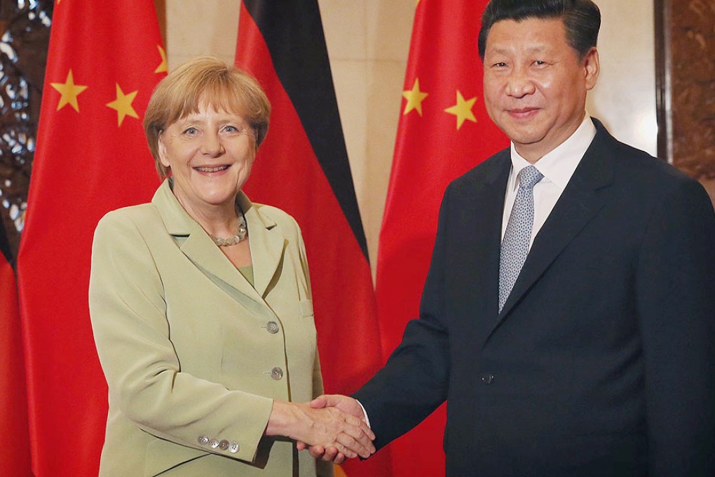 Chinese President Xi Jinping (right) shakes hands with German Chancellor Angela Merkel during their meeting in Beijing. Photo: Xinhua