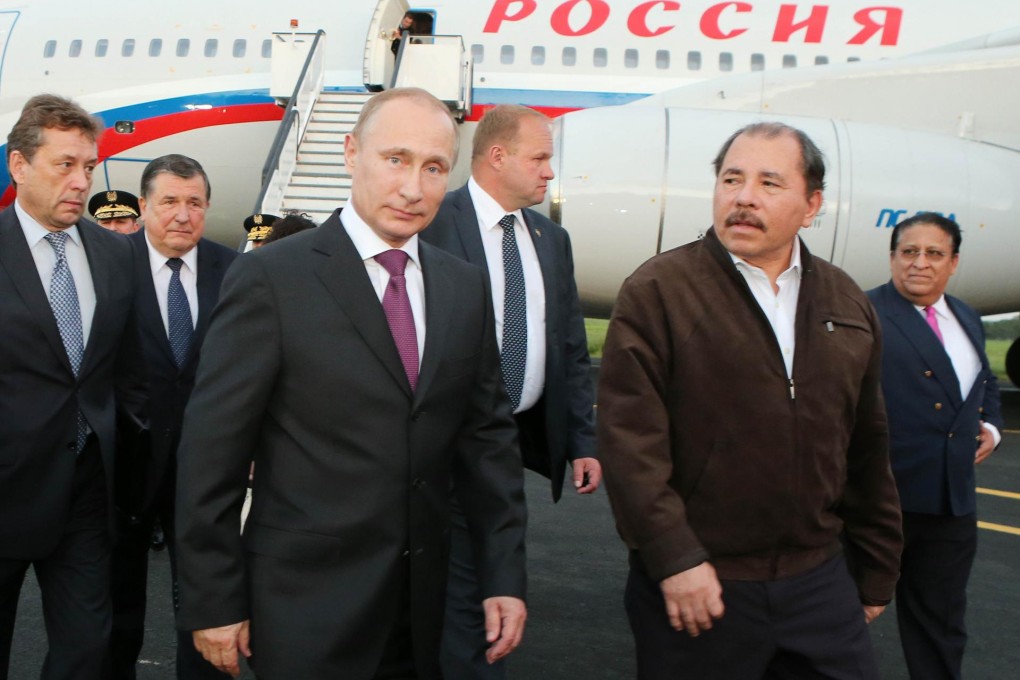 Nicaragua's Daniel Ortega looks towards his guest, Vladimir Putin, after he landed in Managua. Photo: AFP