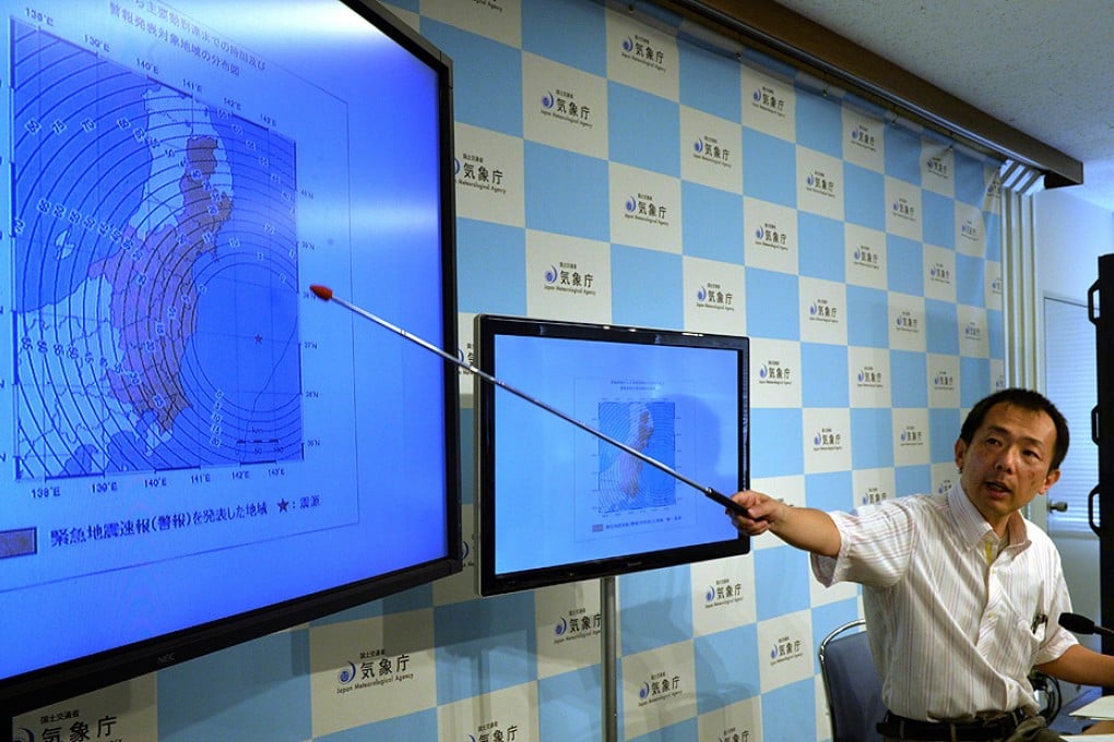 Seismologist Yasuhiro Yoshida explains the quake. Photo: AFP