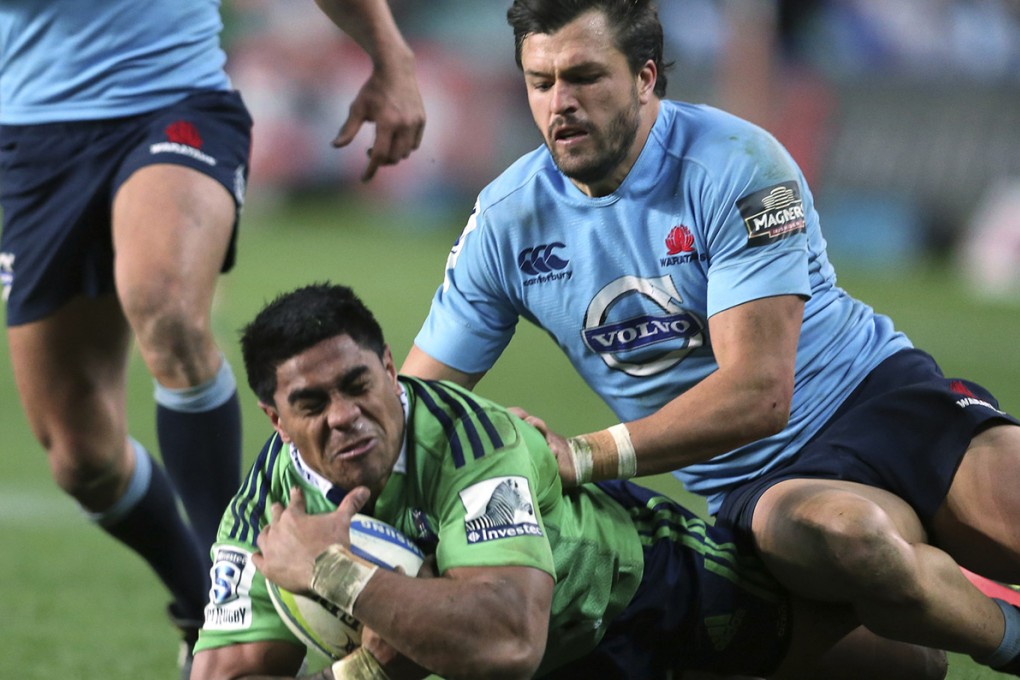 Malakai Fekitoa of the Highlanders is tackled by the Waratahs' Adam Ashley-Cooper during their Super Rugby match in Sydney on 6 July. Photo: AP
