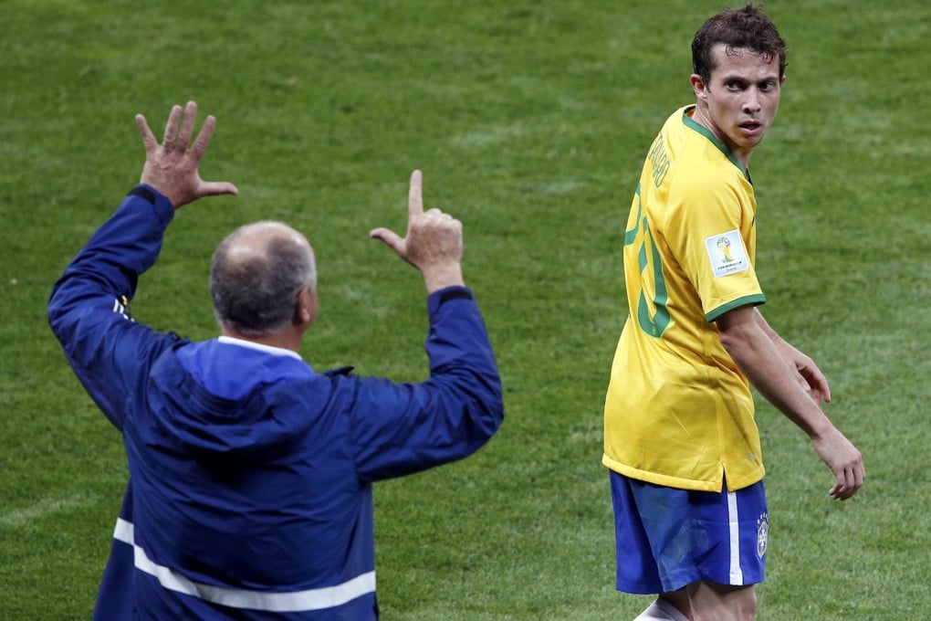 Luiz Felipe Scolari tells Bernard how many goals he needs him to score against Germany. Photo: Reuters