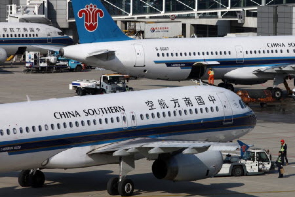 China Southern aircraft are parked at Pudong airport in Shanghai. More than 100 flights were either delayed or cancelled at Pudong and Hongqiao airports today. Photo: Bloomberg