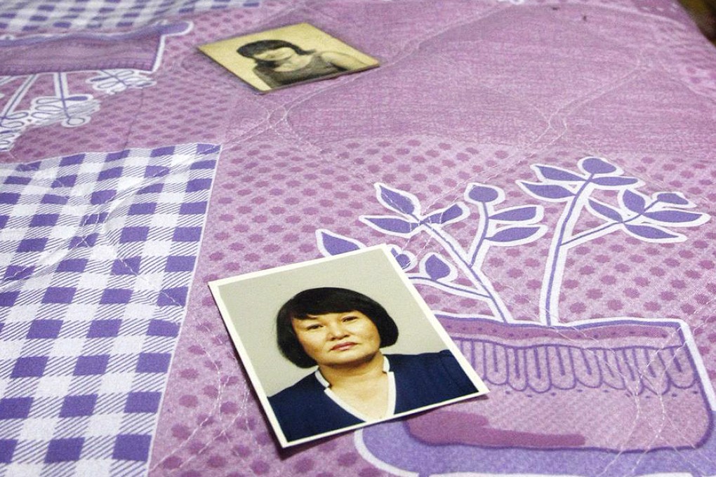 Cho shows photographs of her younger days. She worked as a prostitute for US soldiers. Photo: Reuters