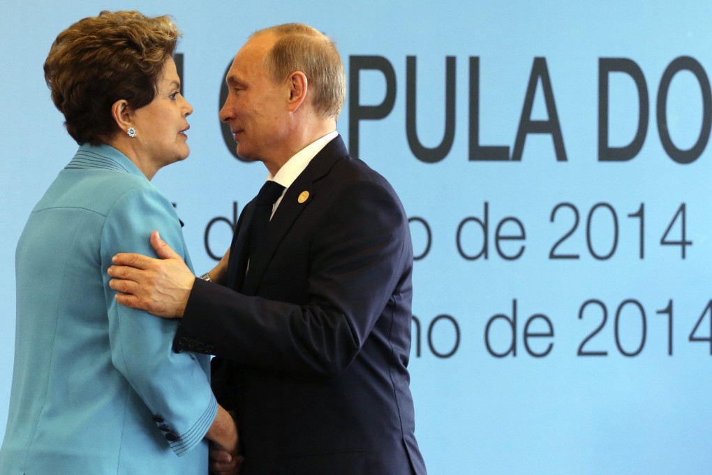 Brazil's President Dilma Rousseff (L) greets Russian President Vladimir Putin before the 6th BRICS summit in Fortaleza. Photo: Reuters