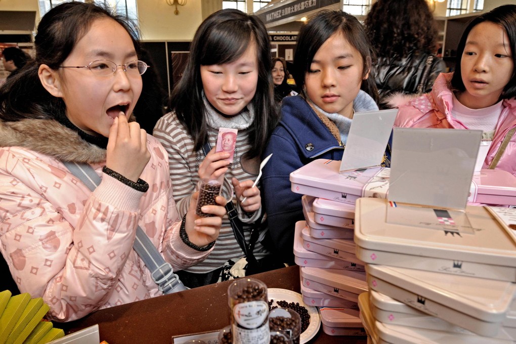 Mainlanders, including these students at a fair in Shanghai, are acquiring a taste for chocolate in line with rising incomes. Photo: AFP