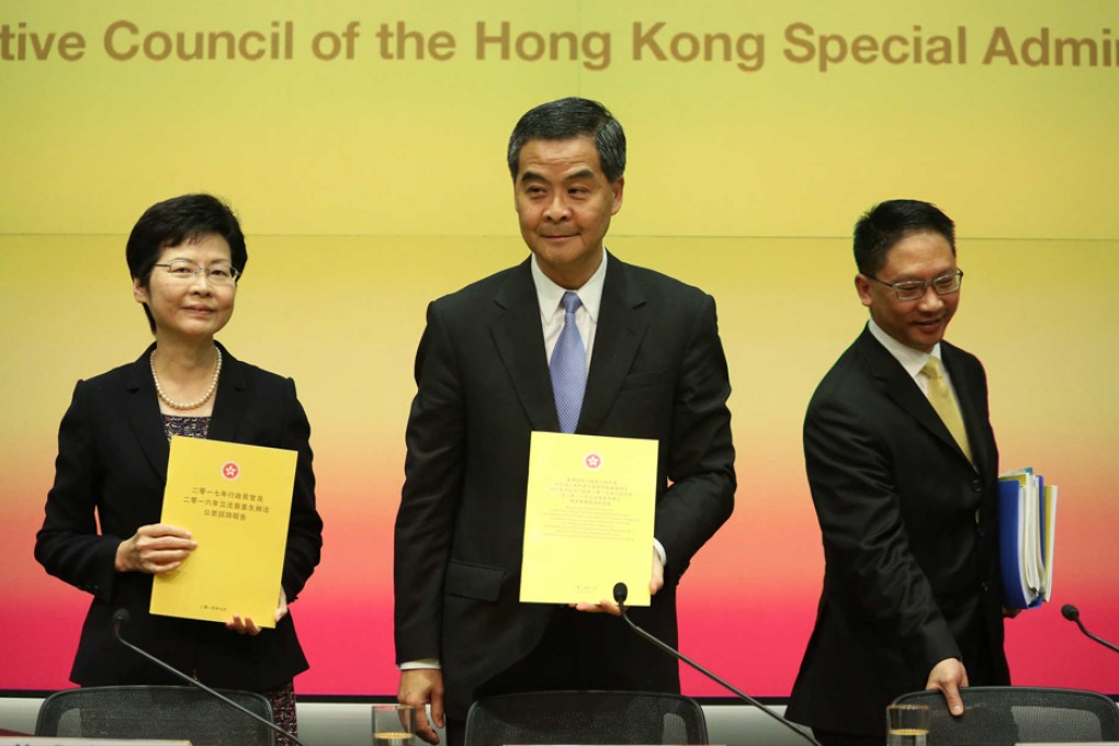The chief secretary, chief executive and justice secretary unveil the reports earlier on Tuesday. Photo: K.Y.Cheng