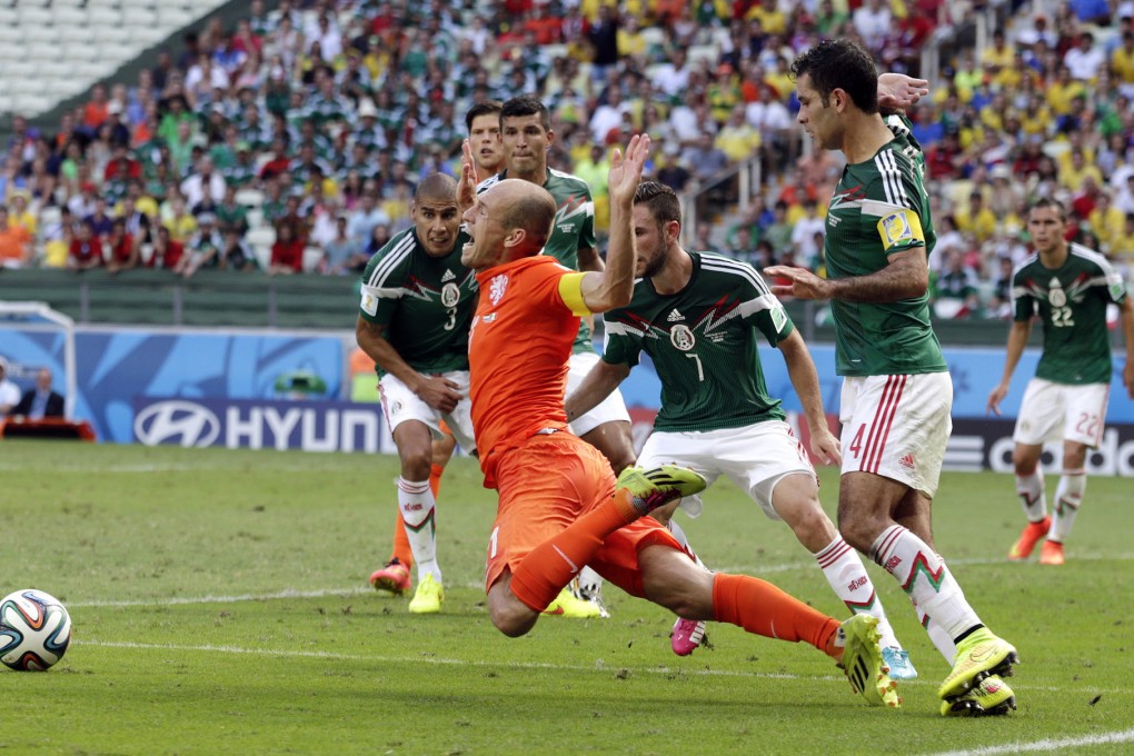 The Netherlands' Arjen Robben goes down to win a penalty against Mexico during their last 16 game, which the Dutch won 2-1. Photo: AP