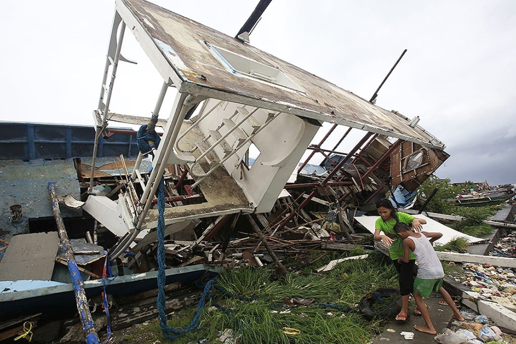 A boat destroyed by strong winds lies in Manila Bay. Photo: Reuters