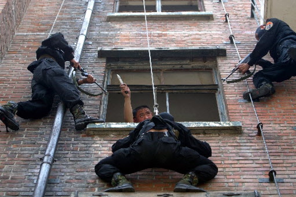 A "terrorist" played by a Chinese soldier is surrounded by special forces during an anti-terrorist exercise in Beijing. Photo: Reuters
