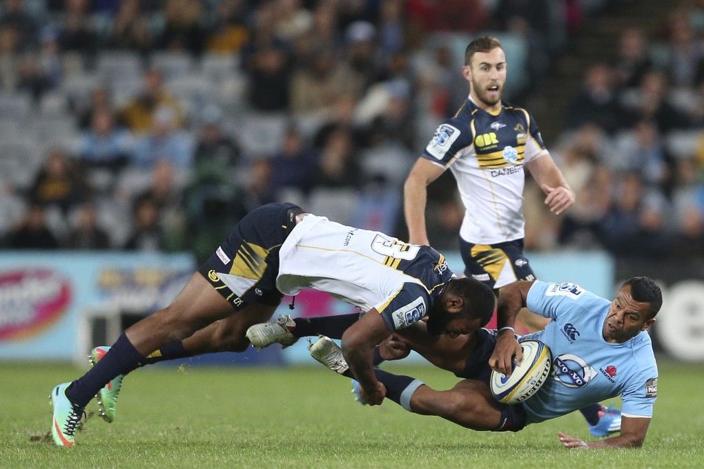 Brumbies’ Tevita Kuridrani tackles Kurtley Beale of the Waratahs during a Super Rugby match in Sydney. Photo: AP
