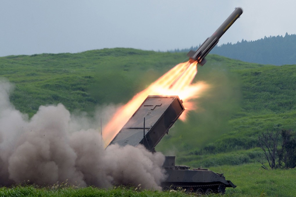 A Japanese Self-Defense Forces type-92 anti-mine rocket launcher fires a missile during an annual live fire exercise in August 2013 in this file image. Photo: AFP