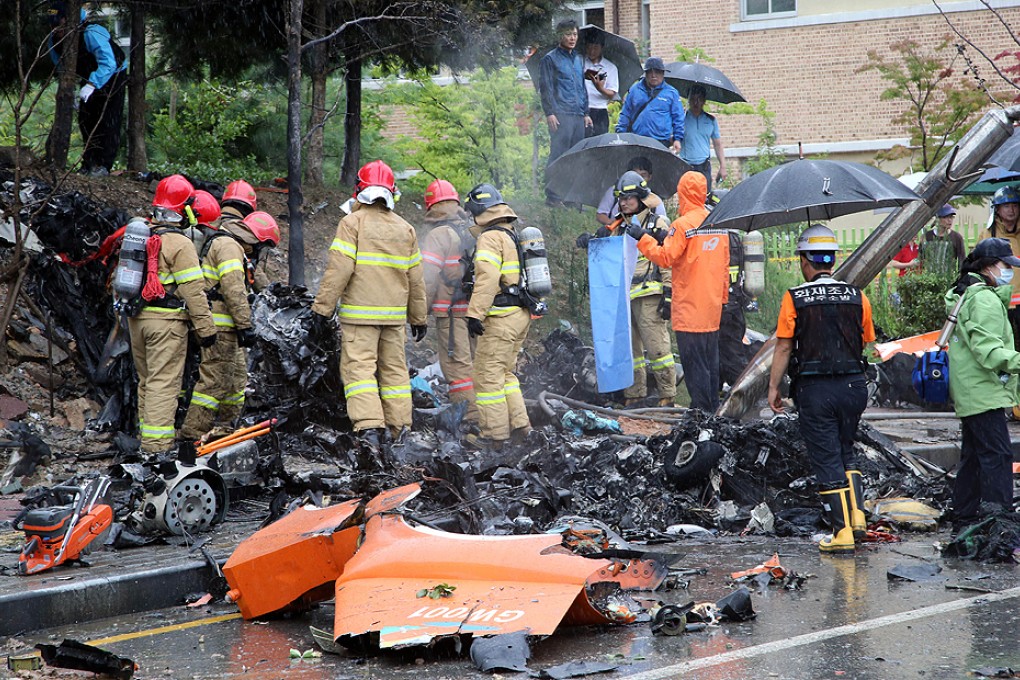 South Korean rescue services gather around the wreckage of a helicopter following a crash in the southern city of Gwangju on Thursday. Photo: AFP