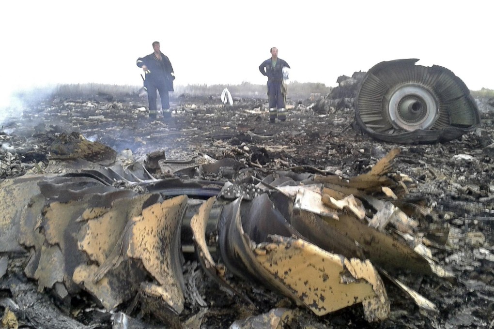 Ukrainian workers at the crash site of a Malaysia Airlines Boeing 777. Photo: Reuters