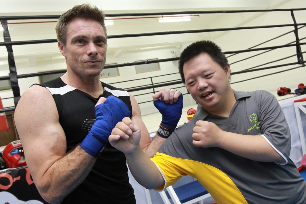 Mark Daniels (left) poses with Macau Special Olympics athlete Che Chio Ip at the Man O War Boxing Club in Macau. Photo: Edward Wong