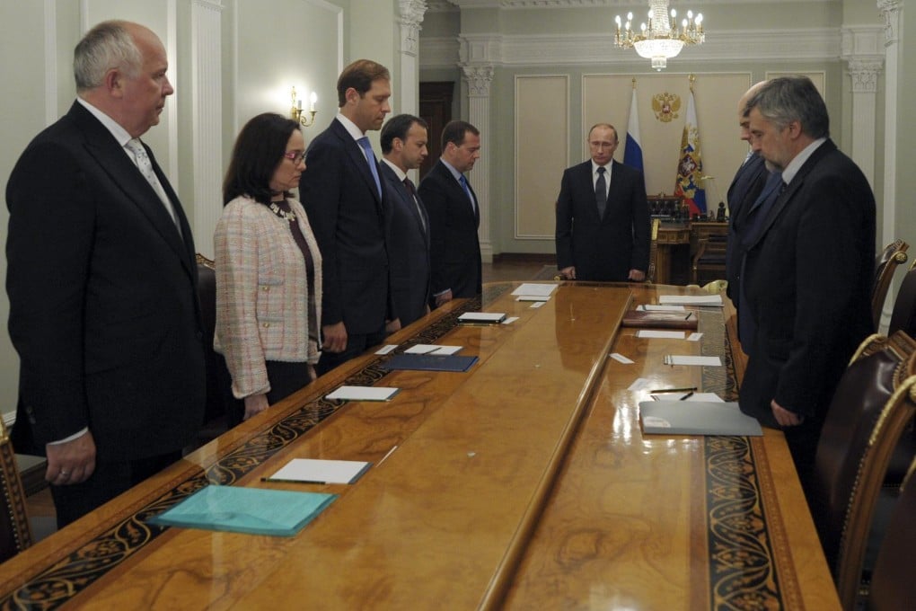 Russia's President Vladimir Putin and officials observe a minute's silence for MH17 victims. Photo: Reuters
