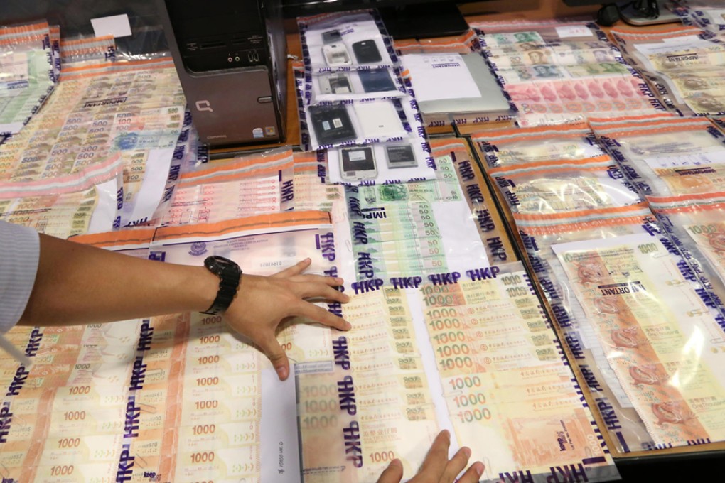 Some of the money seized by Hong Kong police in illegal betting raids across the city, on display at Wan Chai police headquarters. Photo: Sam Tsang