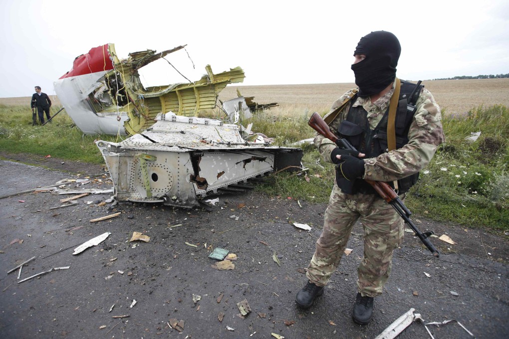 A pro-Russian separatist stands at the crash site of Malaysia Airlines flight MH17. Photo: Reuters