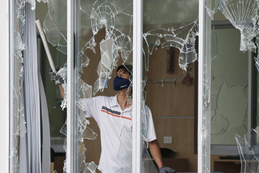 A man clears broken windows at the office of a Taiwanese company attacked in anti-China protests in Vietnam. Photo: Reuters